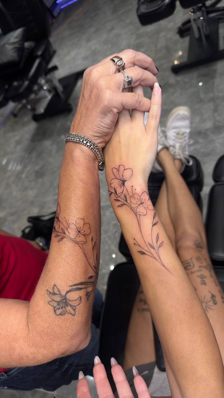 Fine line floral hand tattoos